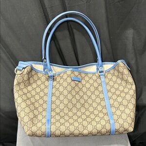 Gucci GG Supreme Joy tote bag featuring blue leather trim
